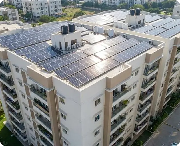 Aerial view of Indian apartment building with large rooftop solar panel installation for residential electricity generation