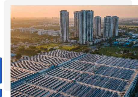Commercial rooftop solar installation in Rajkot with residential towers in the background